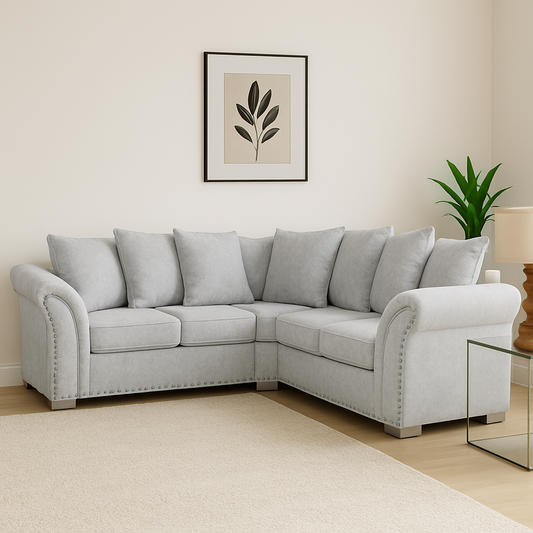 Gray sectional sofa in a living room with a plant and framed artwork on the wall.