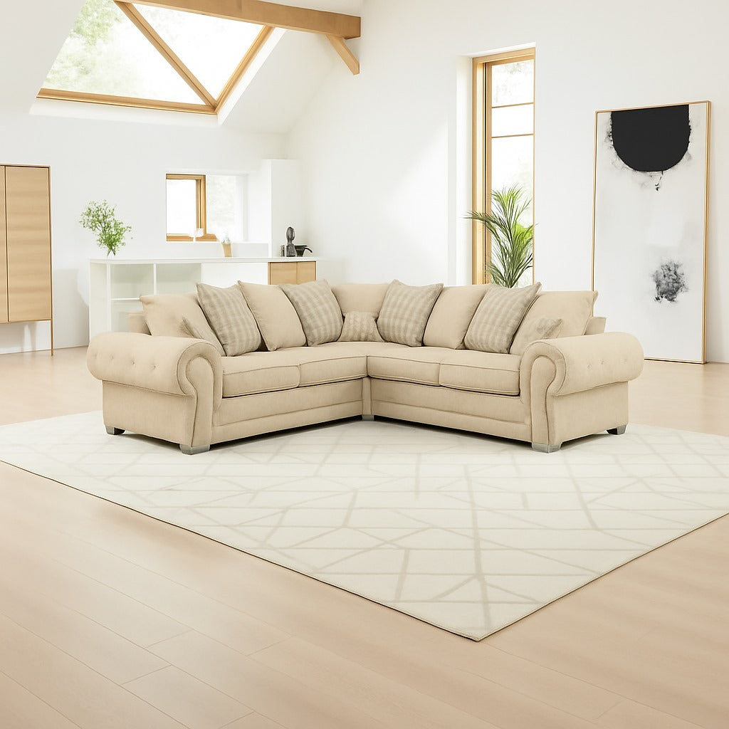Beige sectional sofa in a modern living room with light wood flooring and white walls.